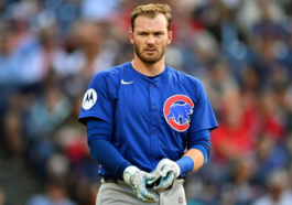 Chicago Cubs player tosses beer money to supporters in the stands on left field